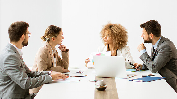 Business men and women sitting around a conference table