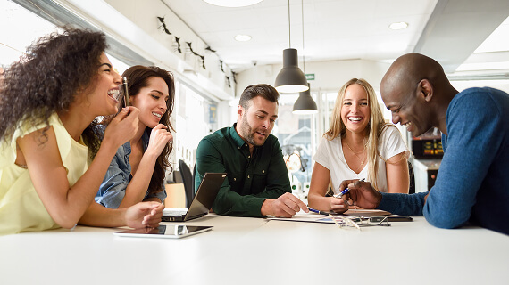 Diverse group of colleagues working together at a large table