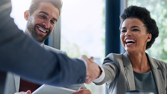 Business woman smiling and shaking hands